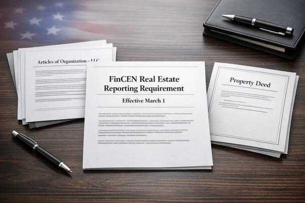 Documents laid out on a wooden desk with paperwork labeled 