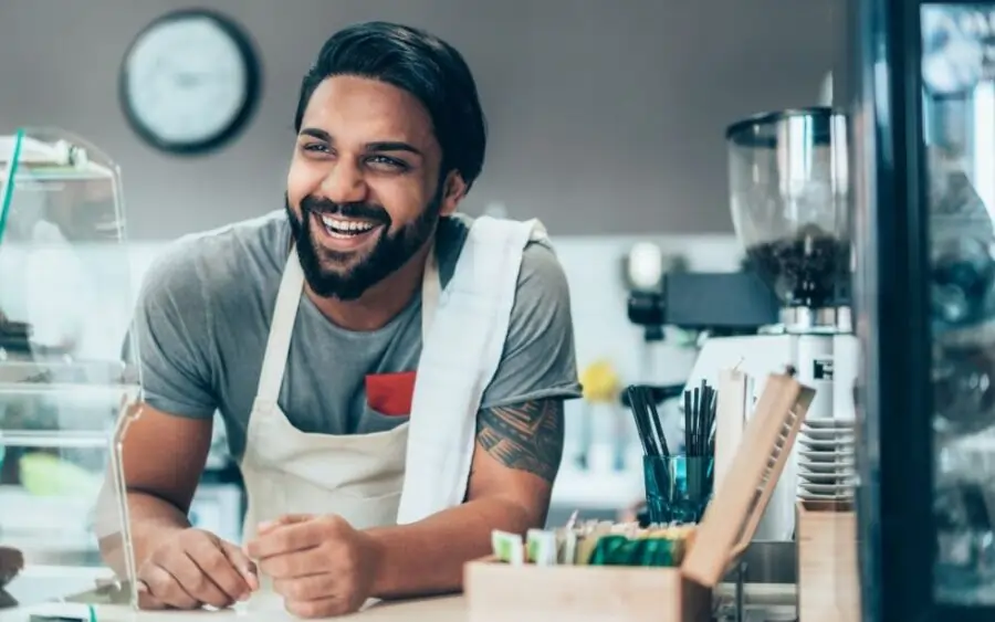 business owner wearing a apron and smiling