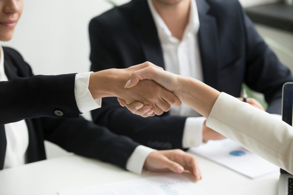 Selling business shaking hands