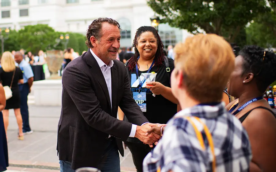 Mark J. Kohler shaking hands