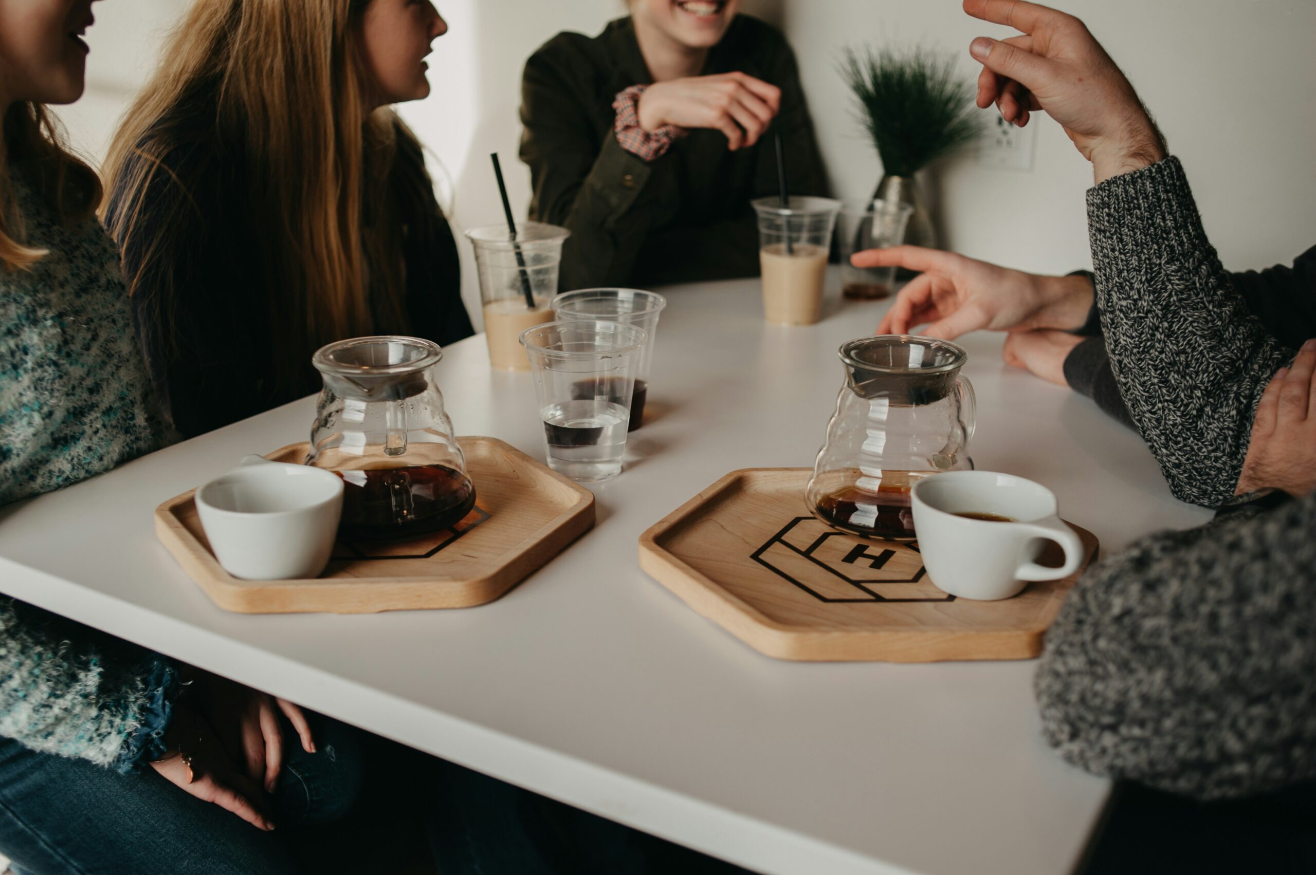 People talking around a table with coffee