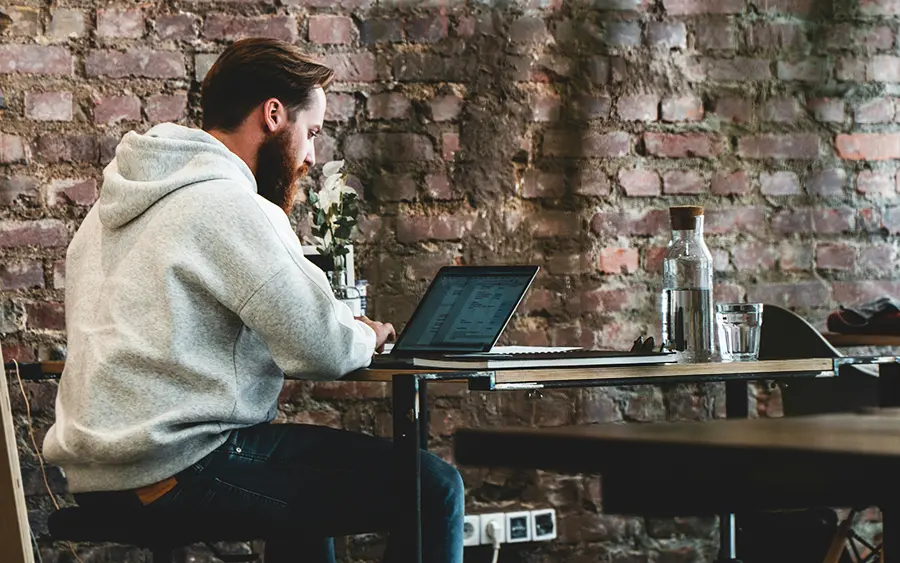 Business person sitting at desk in front of a computer